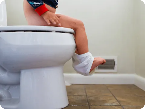 toddler sitting on toilet