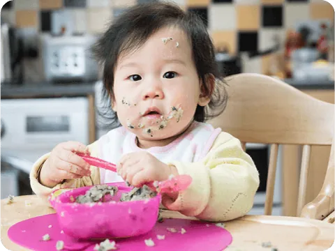 baby sitting on chair eating